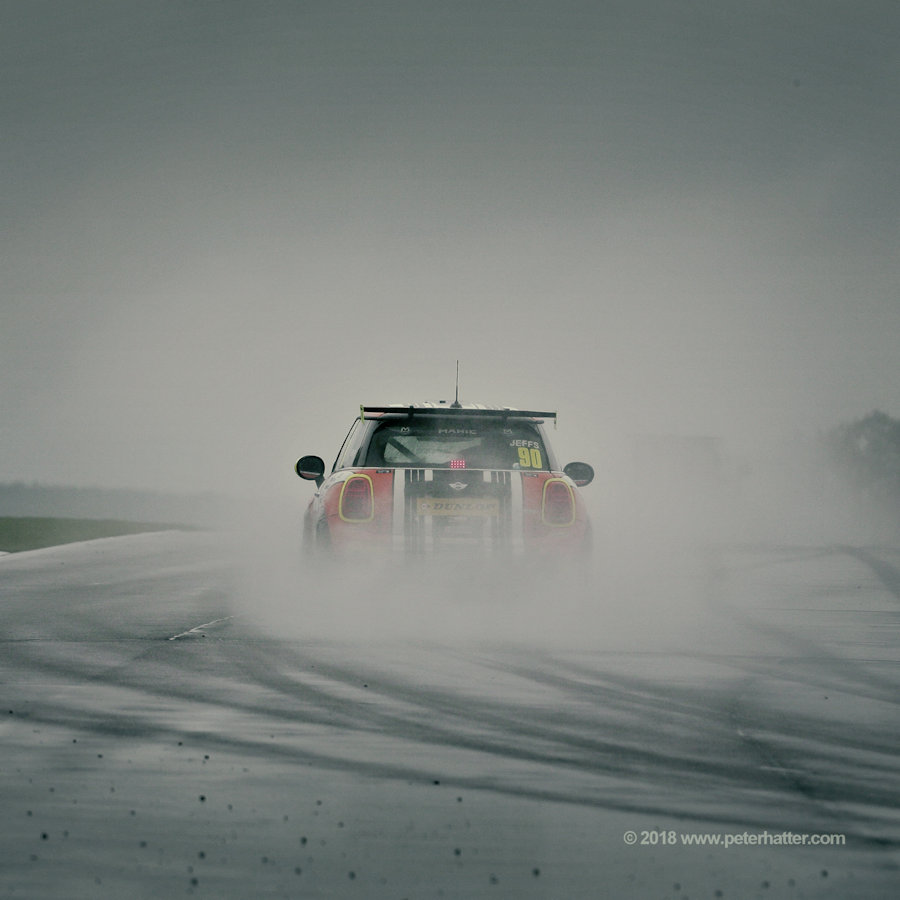 A Mini disappears in to the gloom on the run down to the Melbourne Hairpin at Donington Park