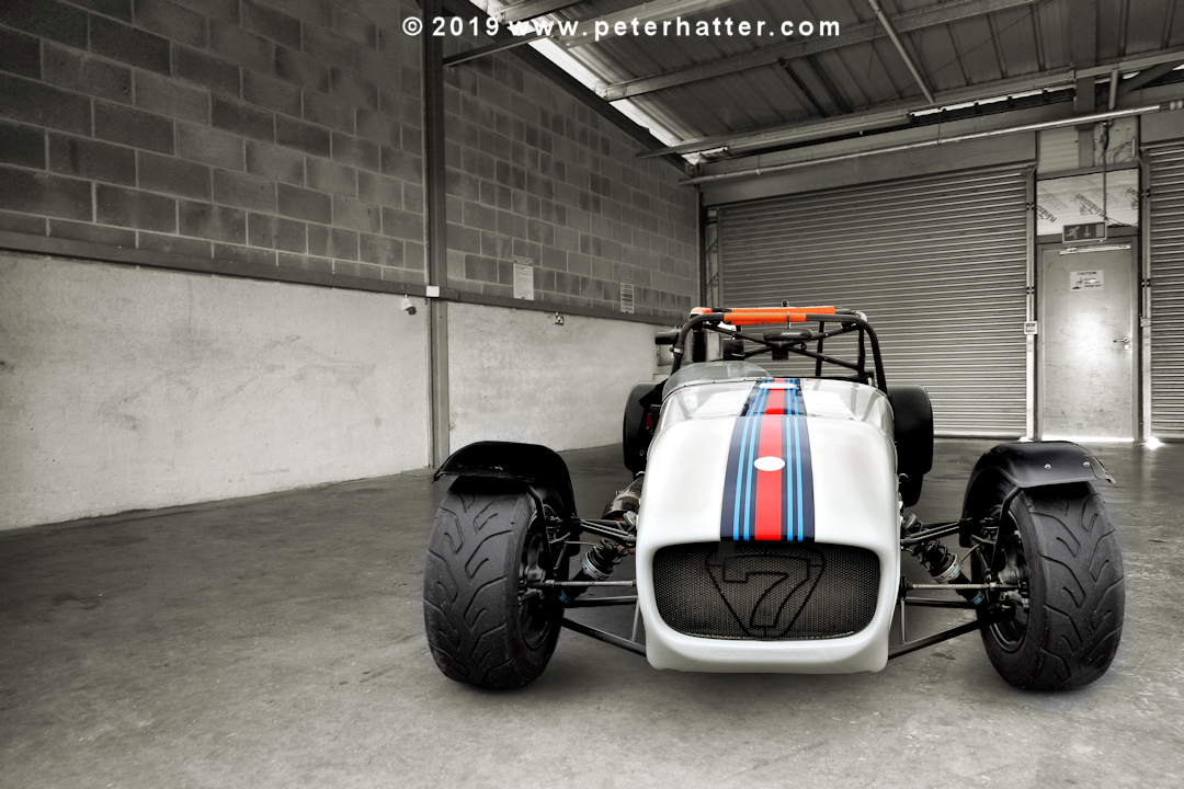 Caterham & in a pit garage.