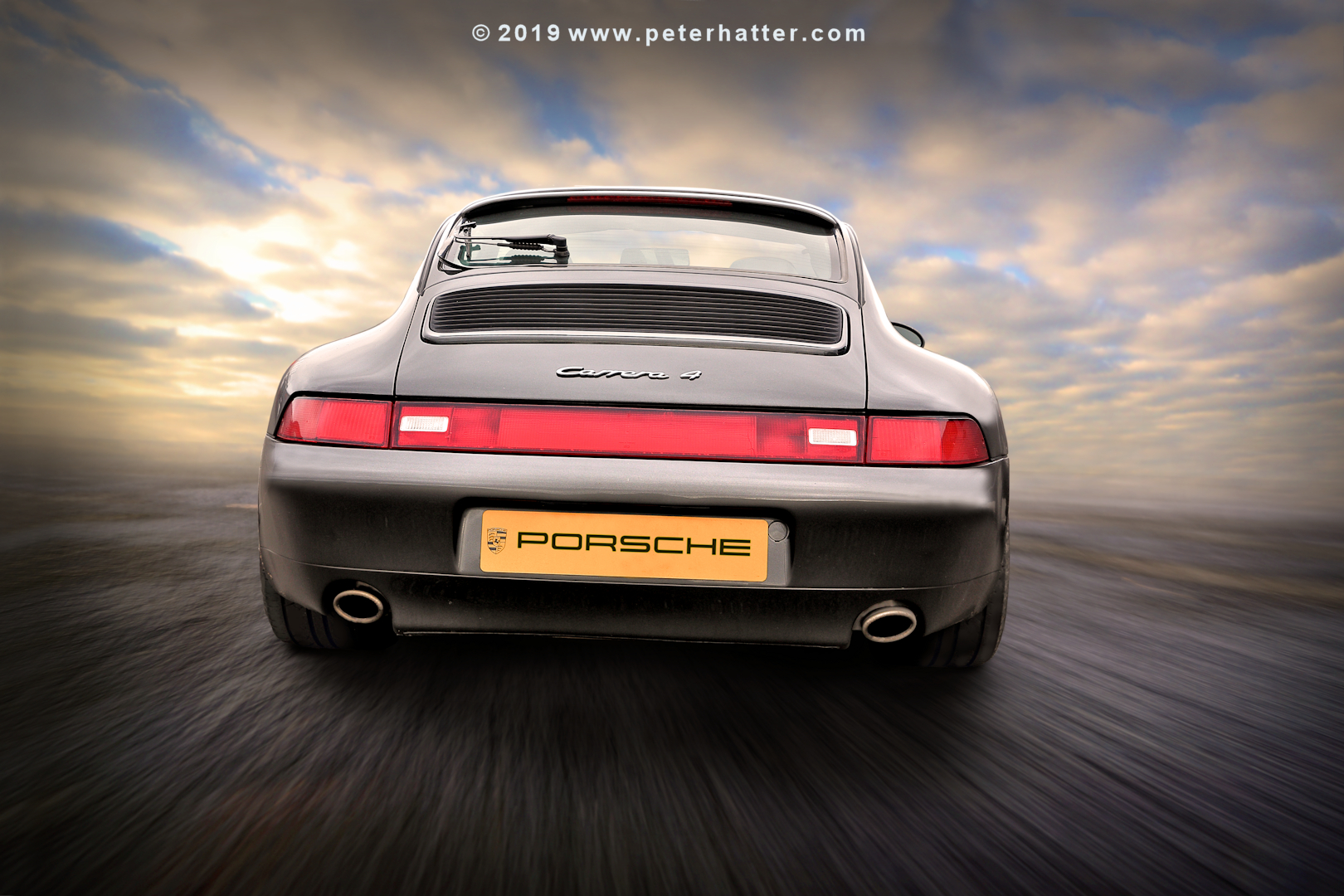 The rear of a Porsche 911 Carrera.