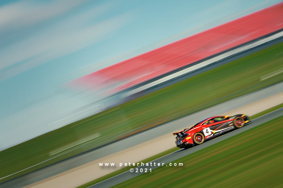 McLaren GT car racing along a track.