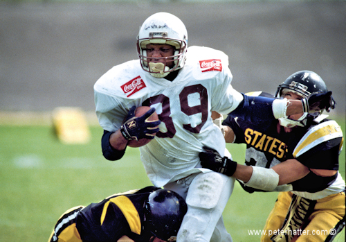 Sports photography example of american football tackle.
